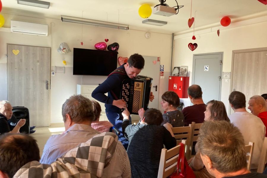 Artysta grający na harmonii dla Uczestników